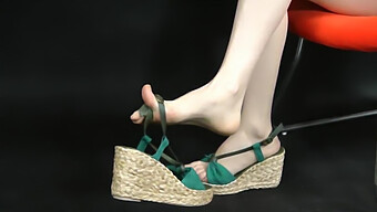 Close-Up Of Asian Feet In Stylish Wedge Espadrilles